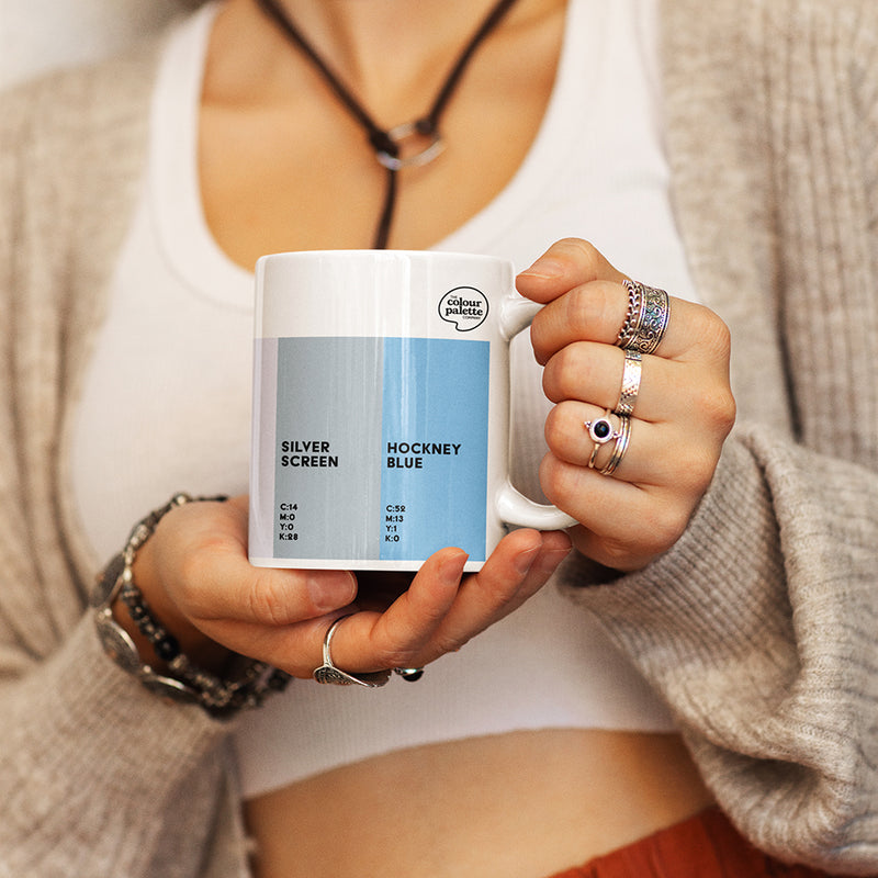 Person holding a Los Angeles Colour Palette mug with color swatches and text
