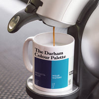 Durham Colour Palette porcelain mug with six colour swatches celebrating Durham Cathedral, the River Wear, Chester-le-Street cricket and County Durham mining.