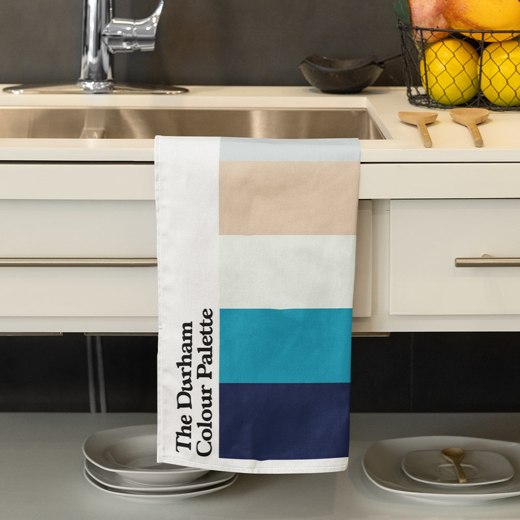Durham Colour Palette cotton tea towel featuring six colours celebrating Durham Cathedral, the River Wear, Durham Regatta and County Durham mining heritage.