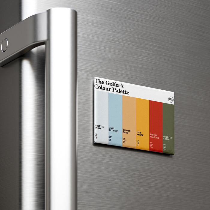 A rectangular magnet displaying 'The Golfer's Colour Palette' with six color swatches, attached to a brushed stainless steel refrigerator door next to a silver handle.