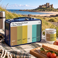 Northumberland metal lunchbox and enamel mug featuring the colours of Northumberland